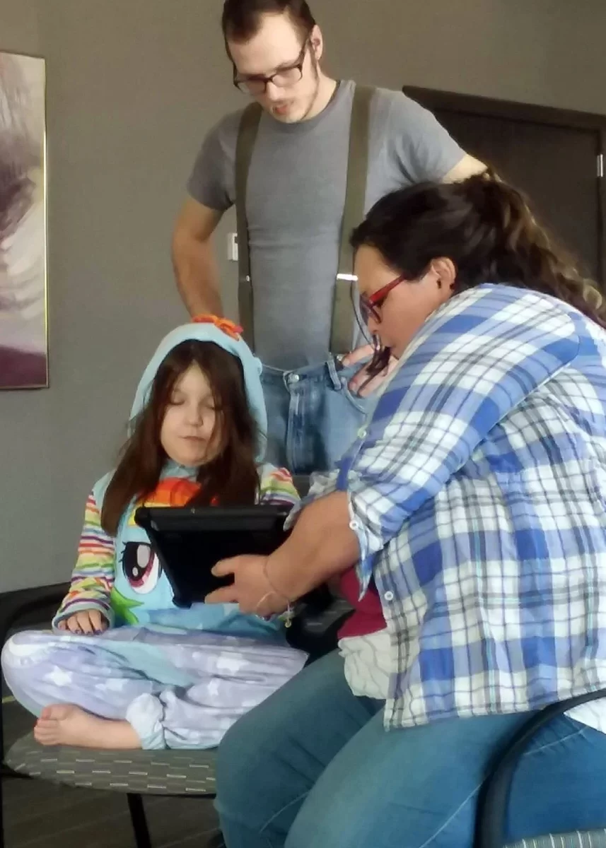 Angie facilitating communication using Ipad with Vivian with her stepdad observing in Waterloo, IA